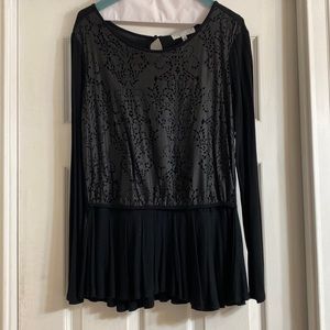 Black long sleeved blouse with layered design on top and flowing bottom